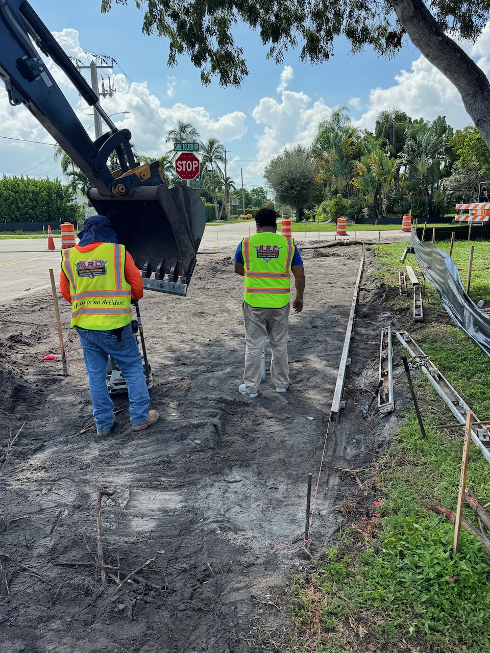 Excavator and crew preparing a sidewalk route