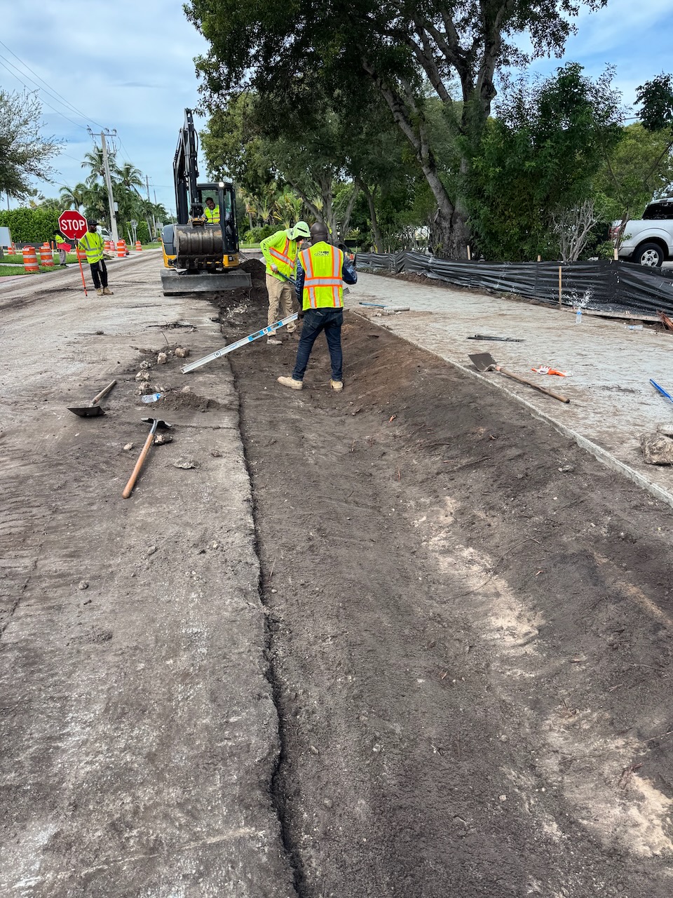 Crew preparing a roadway and sidewalk work area