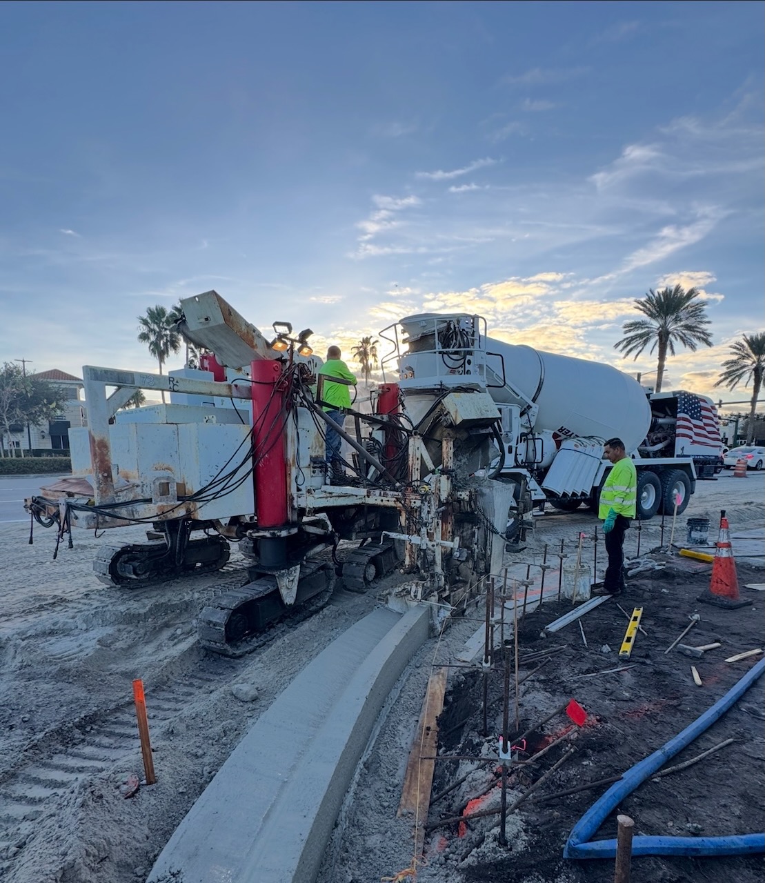 Concrete paving machine and crew at a jobsite