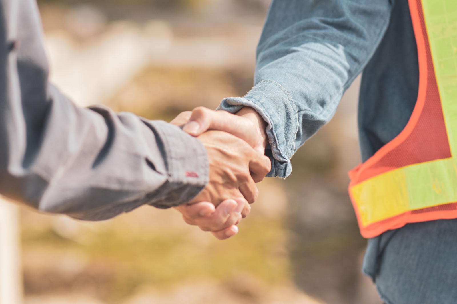Construction partners shaking hands on a jobsite